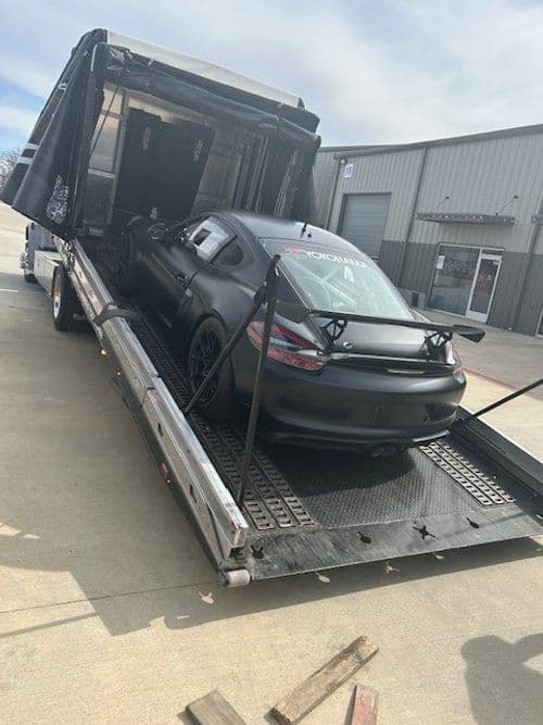 A car is sitting on top of a tow truck