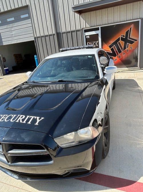 A black car with the word security on the hood